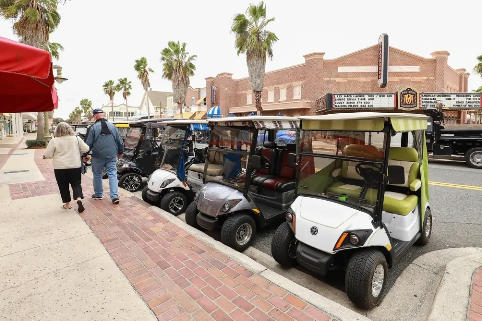 Line of golf carts parked on street in The Villages, Florida
